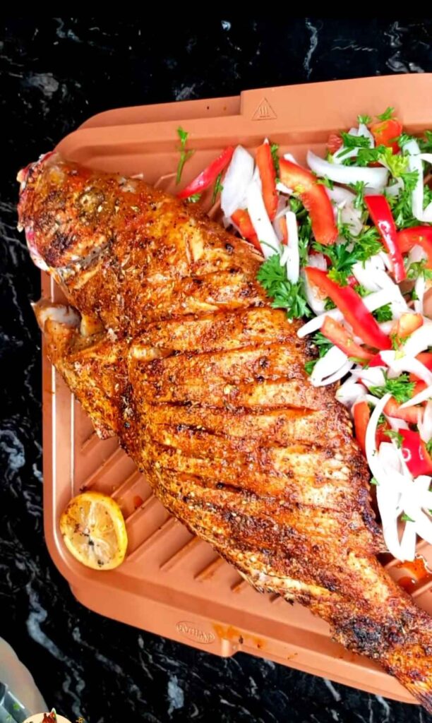A whole oven grilled fish kept on a tray